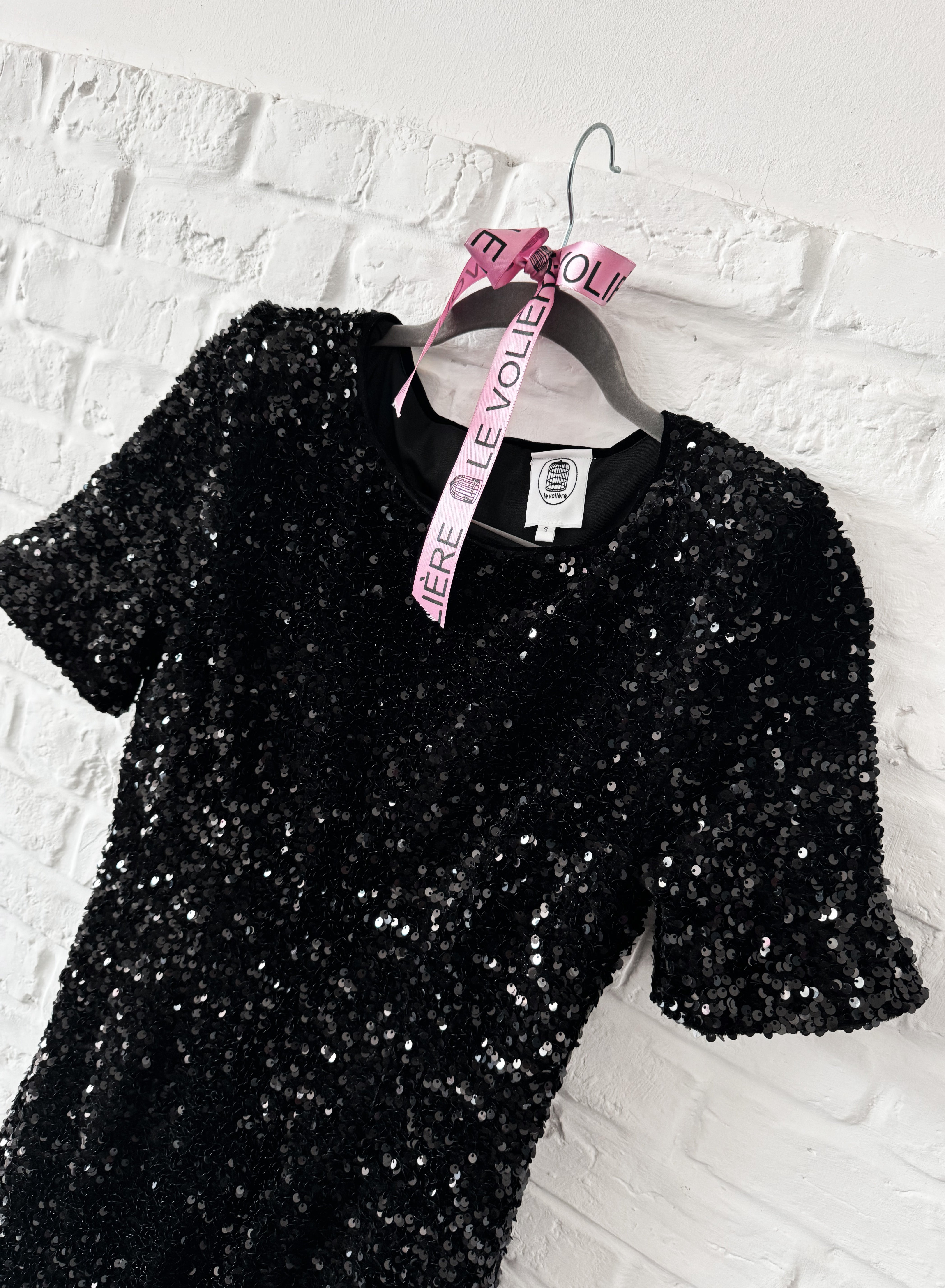 Vestito nero di paillettes con piume